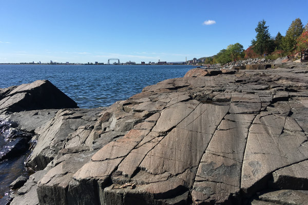 Rock slabs on a lakeshore display glacial polishing and striations.