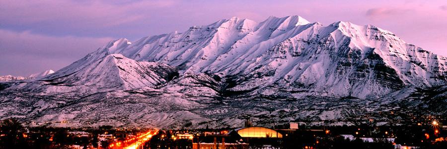 A snow-caked Mount Timpanogos bathed in purple alpenglow.